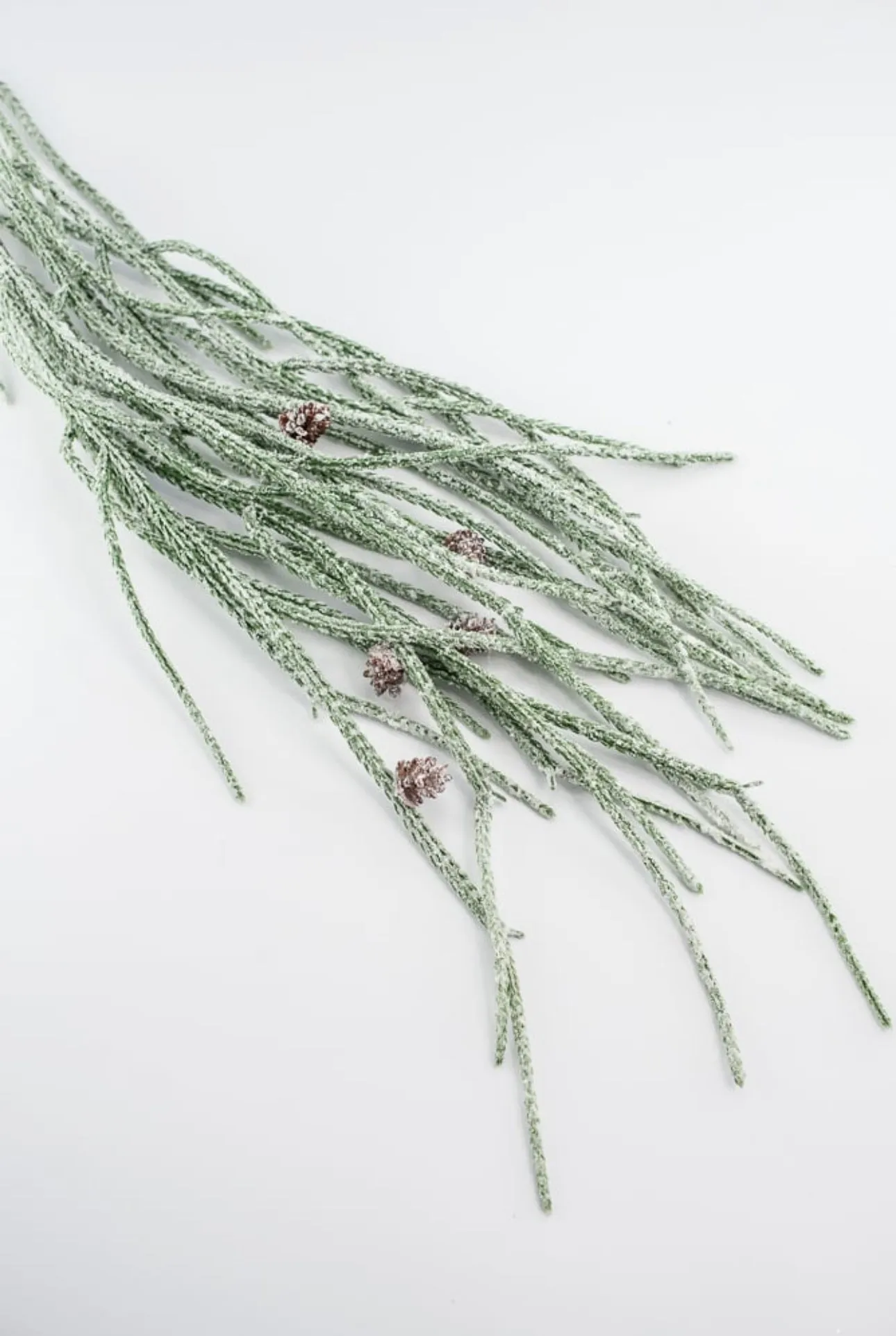 Artificial, frosted, weeping greenery branch