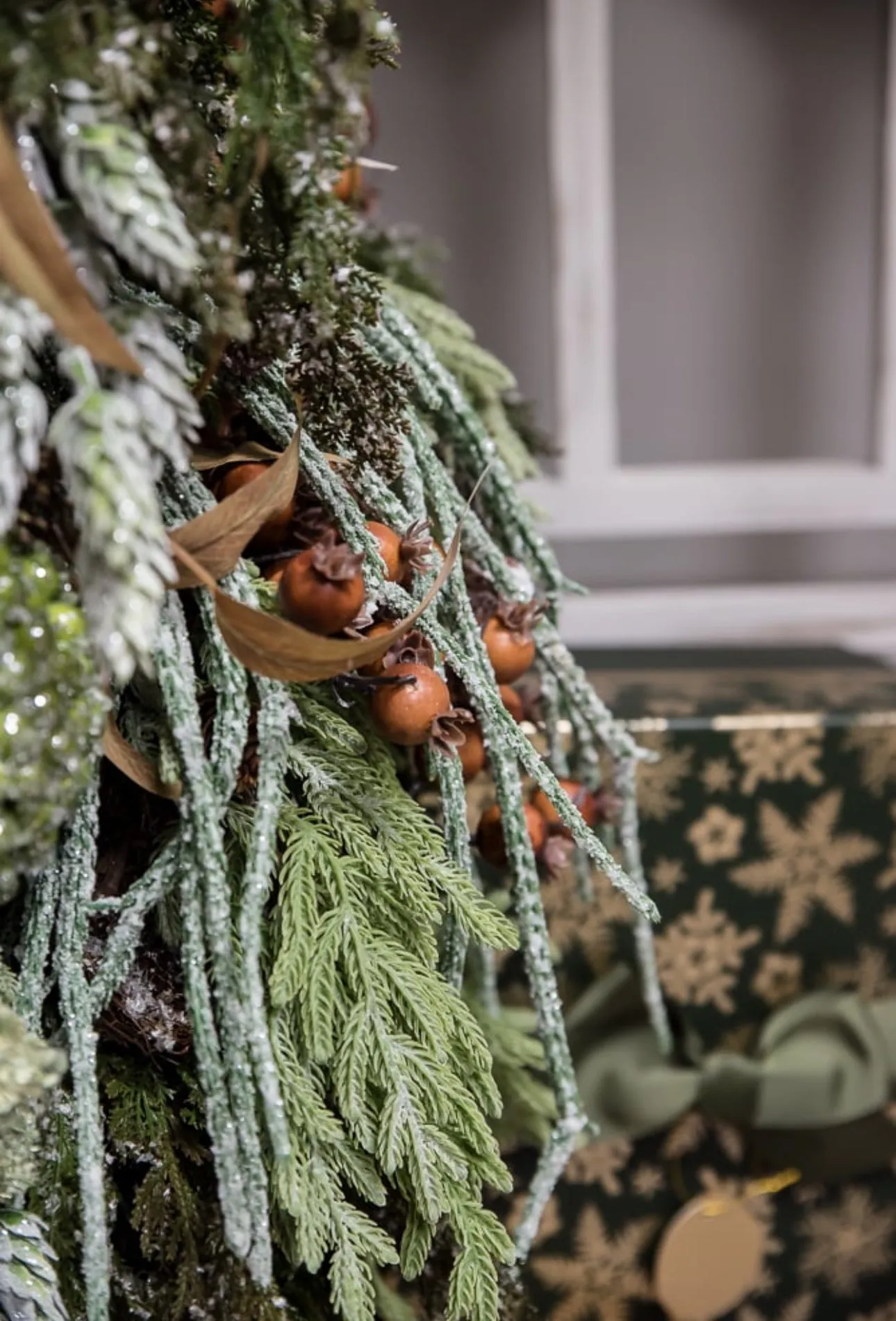 Artificial, frosted, weeping greenery branch