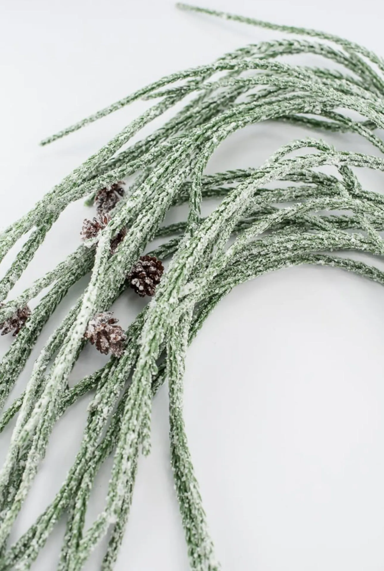 Artificial, frosted, weeping greenery branch