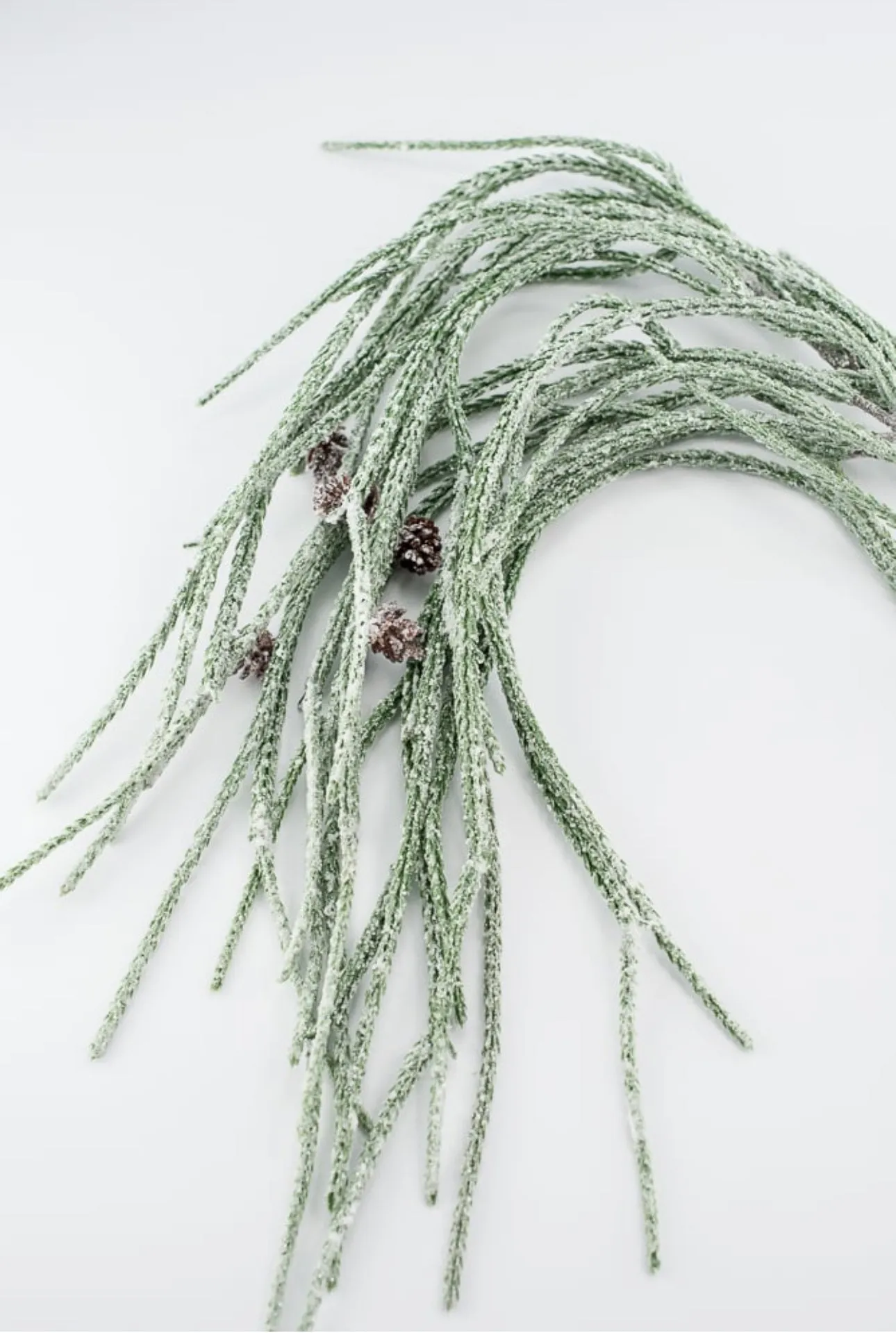 Artificial, frosted, weeping greenery branch