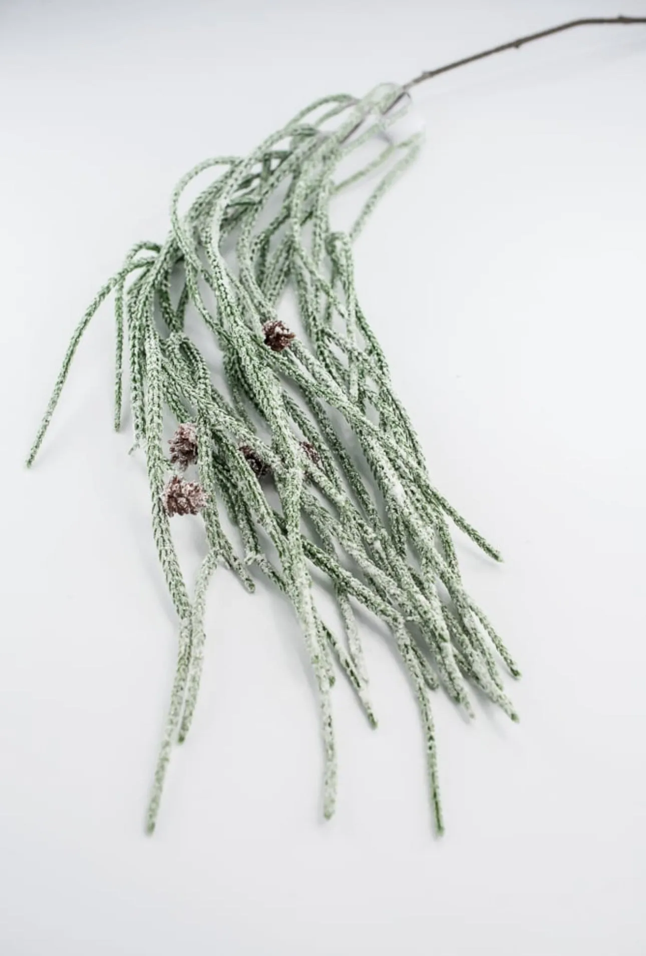 Artificial, frosted, weeping greenery branch