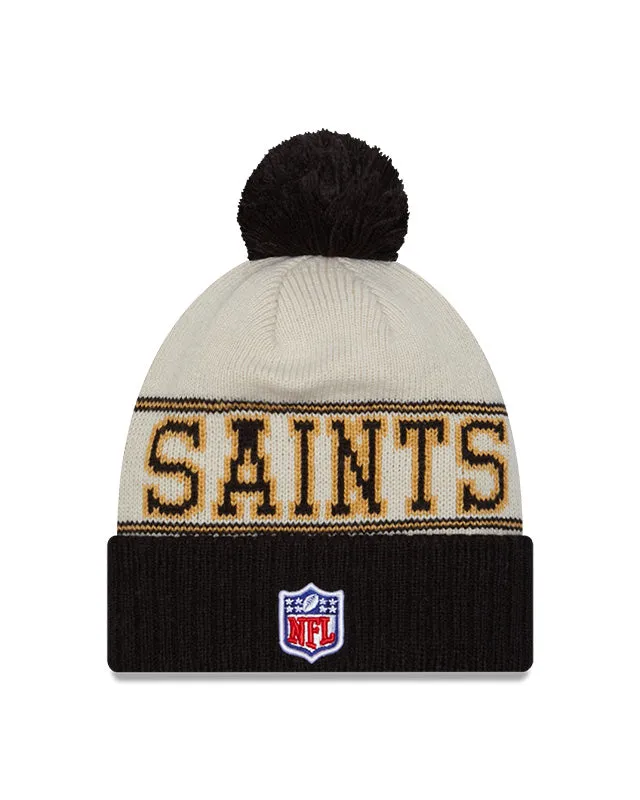 New Orleans Saints New Era 2023 Sideline Historic Pom Cuffed Knit Hat - Cream/Black